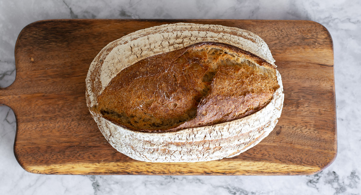 Bio Bauernbrot auf Holzbrett und Marmorplatte